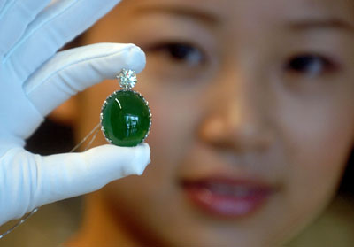 Saleswoman Displays Emerald Pendant photo image